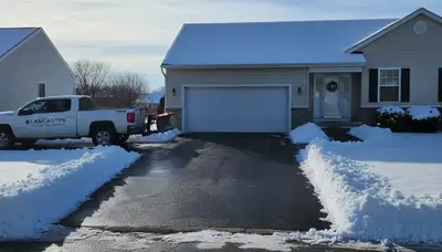Clean residential driveway after expert snow removal by Chop Chop Landscaping in Lancaster, PA